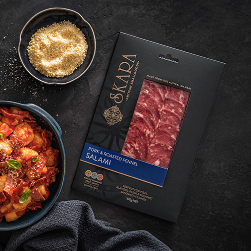 Skara Smallgoods Pork and Fennel Salami Pack with bowl of pasta and sprinkle of parmesan on dark background